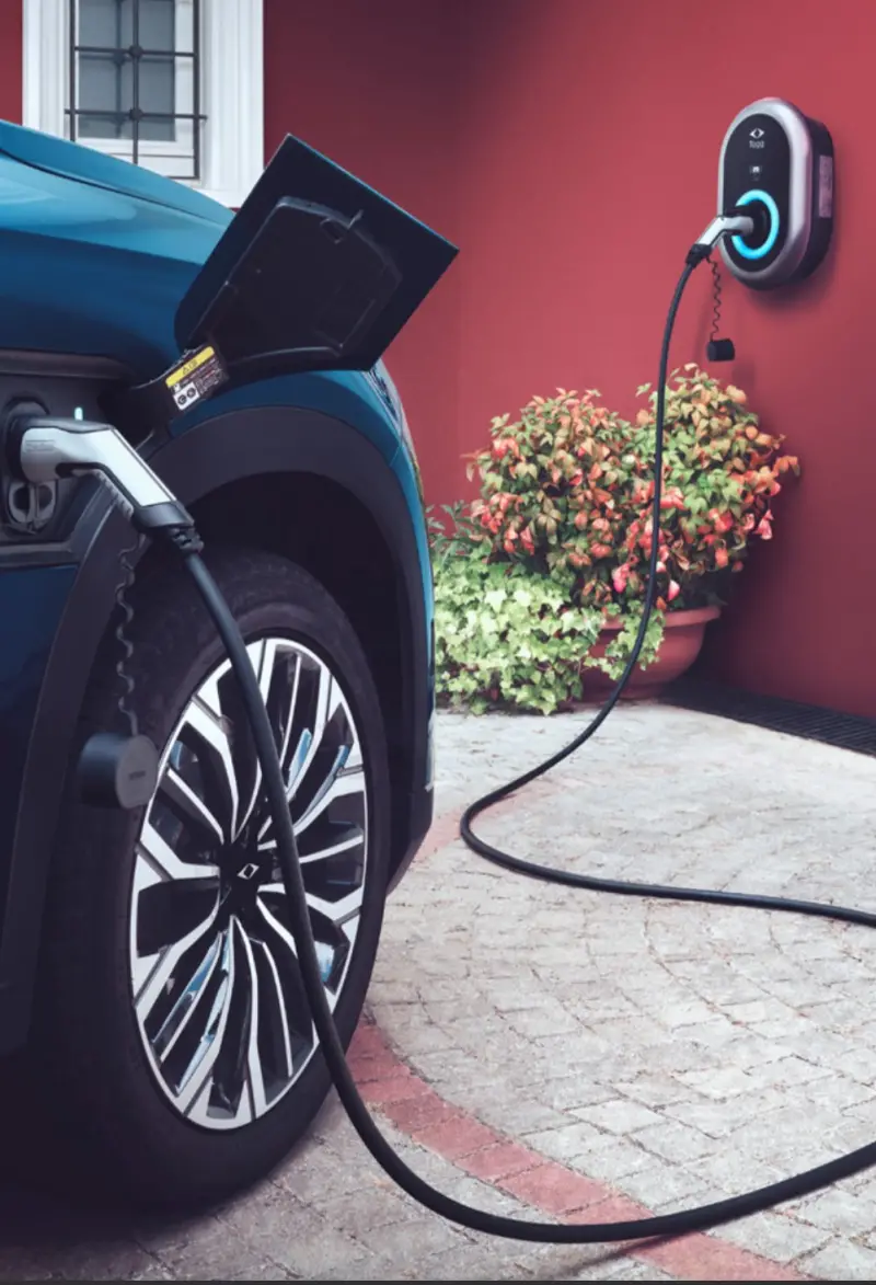 Electric vehicle charging cable plugged into a wall charger