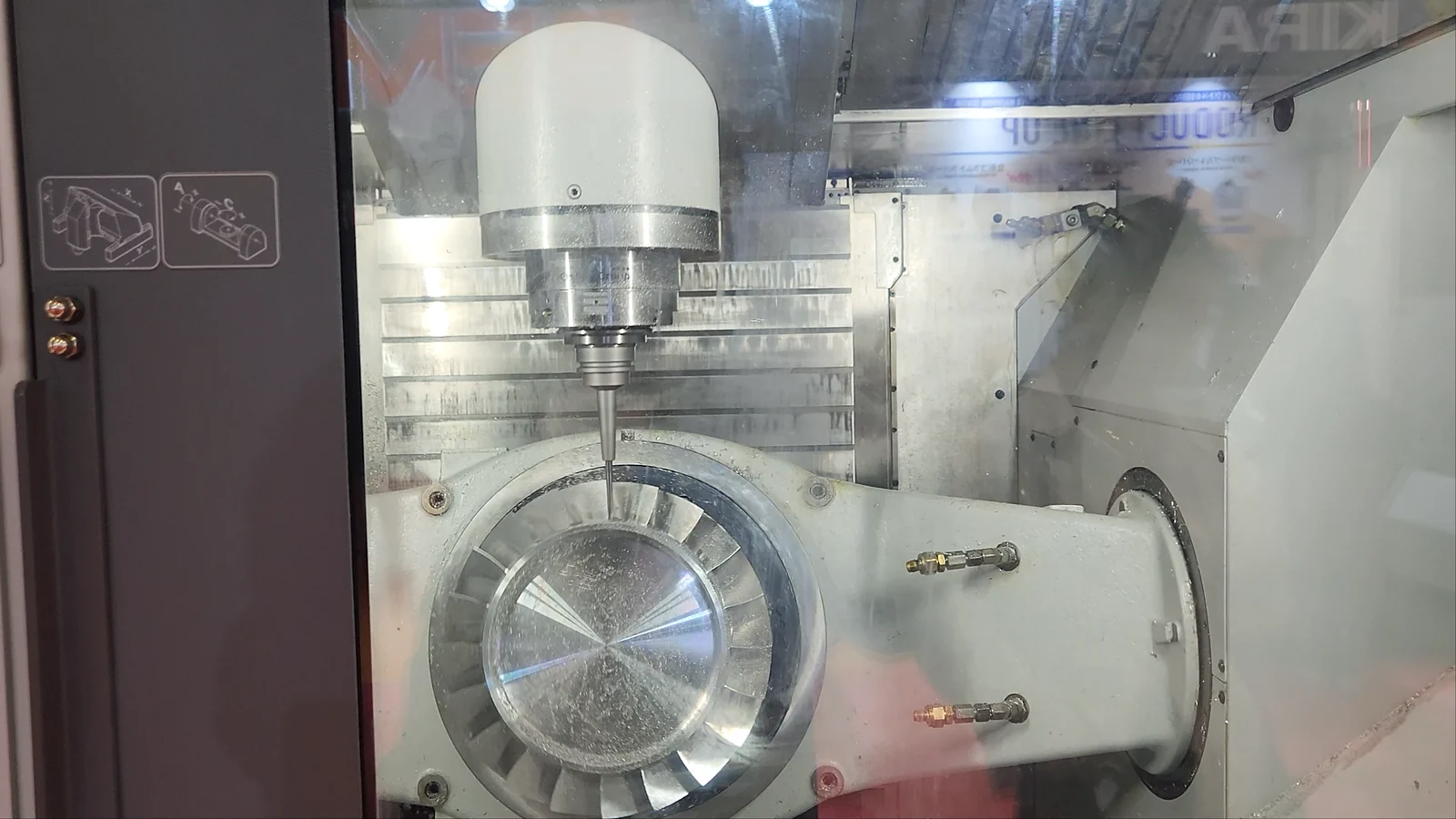 Simultaneous 5-axis machining: an impeller-type part being cut on a rotary table