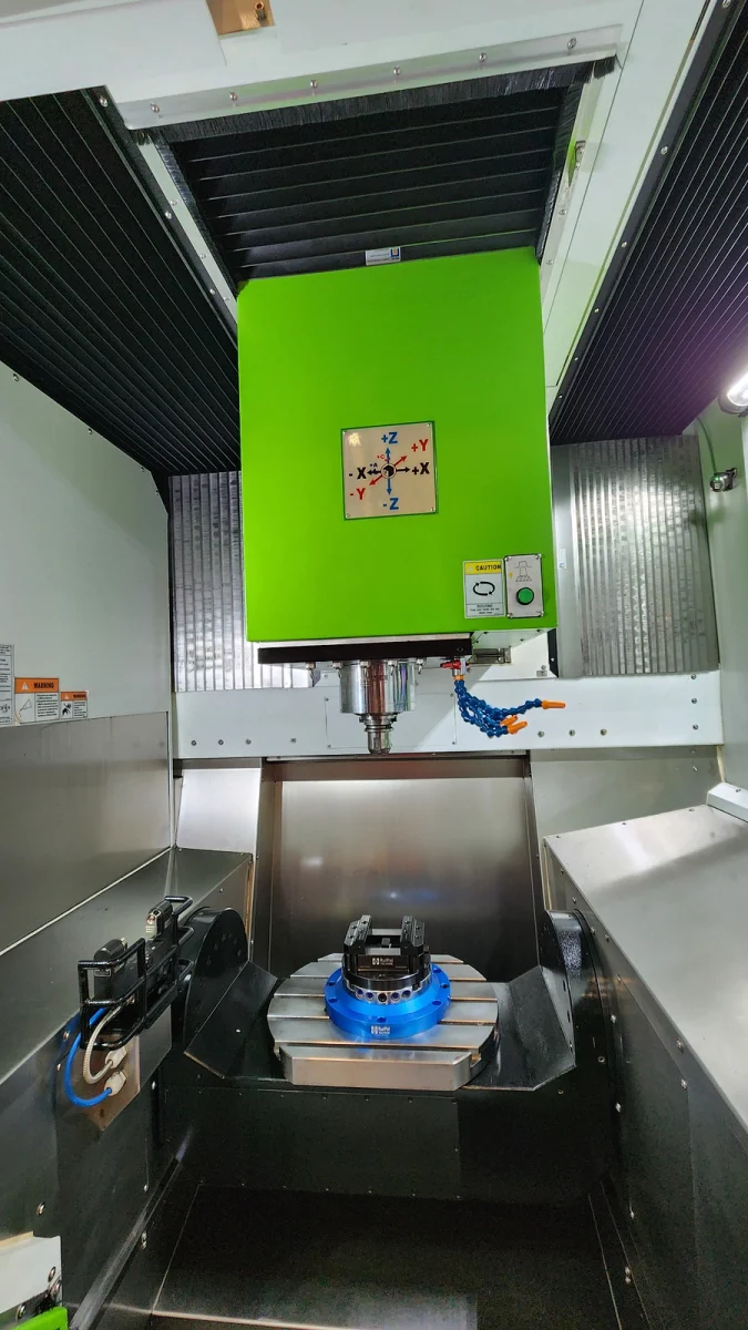 Axis direction label (X, Y, Z) on a vertical machining center with a tilting rotary table